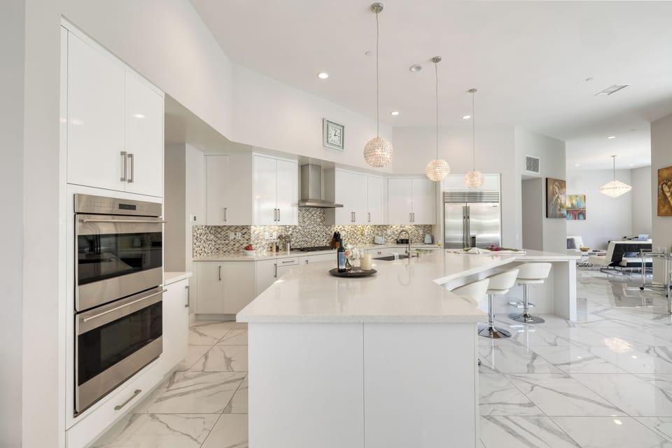 Bright, fully equipped kitchen with ample prep space.