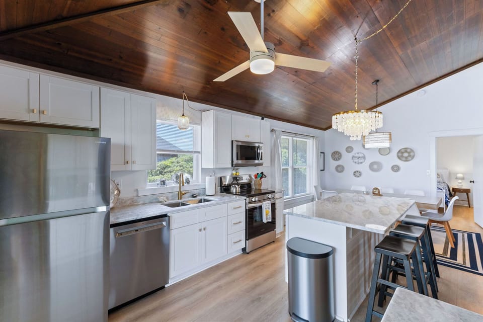 Kitchen - This kitchen is to die for with elegant lighting, stainless appliances, and an ocean view.