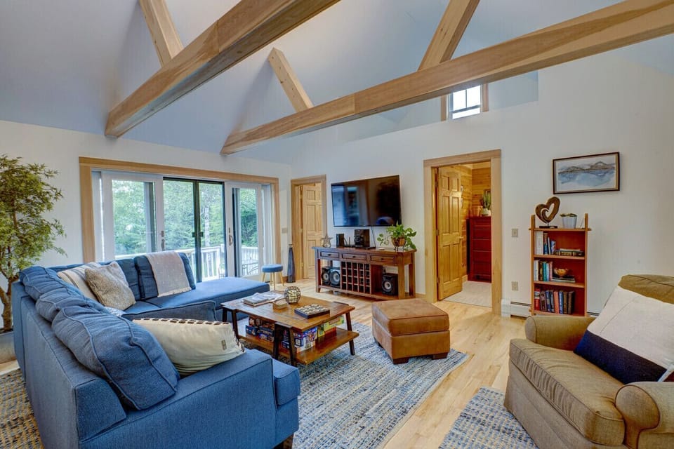 Large, cozy living room with doors out to a front deck and a 3rd deck out the backdoor.