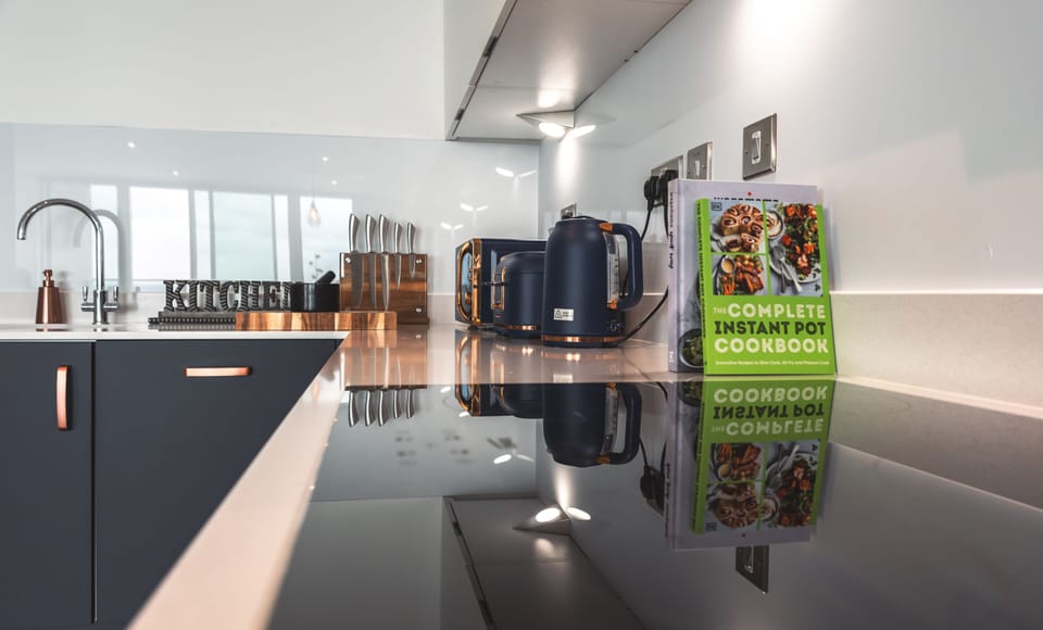 Sleek and modern kitchen, outfitted with top-tier utensils and appliances,