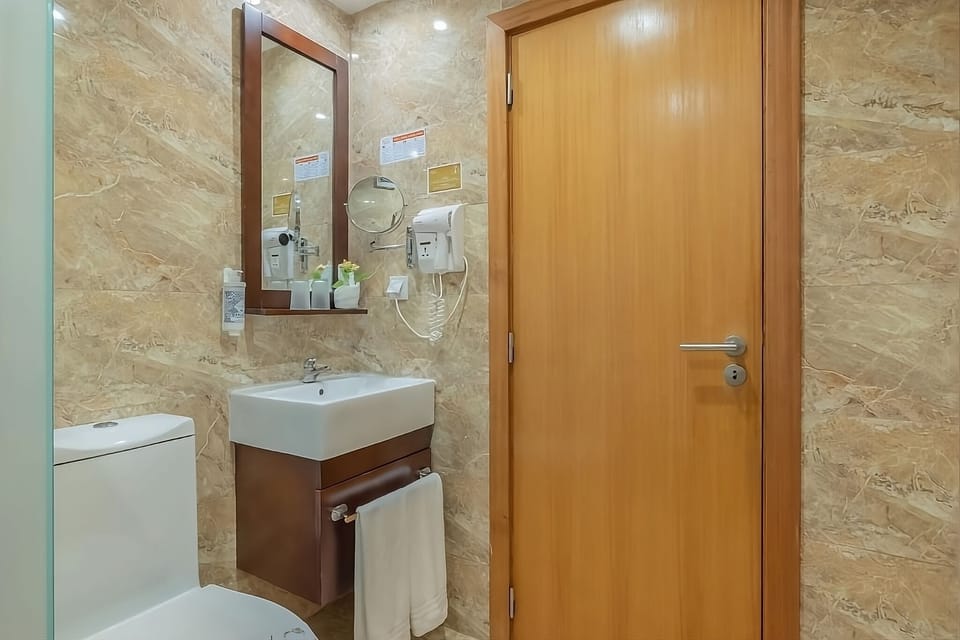 Unwind after adventures in this sleek, marble-styled bathroom.