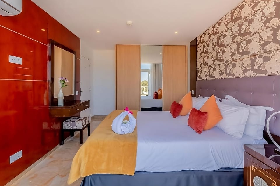 Unwind in a stylish bedroom with crisp linens and calm lighting.
