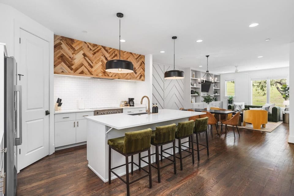 High-end appliances, large pantry, and all the cooking supplies you might need in this bright & fresh kitchen with seating for four at the island.