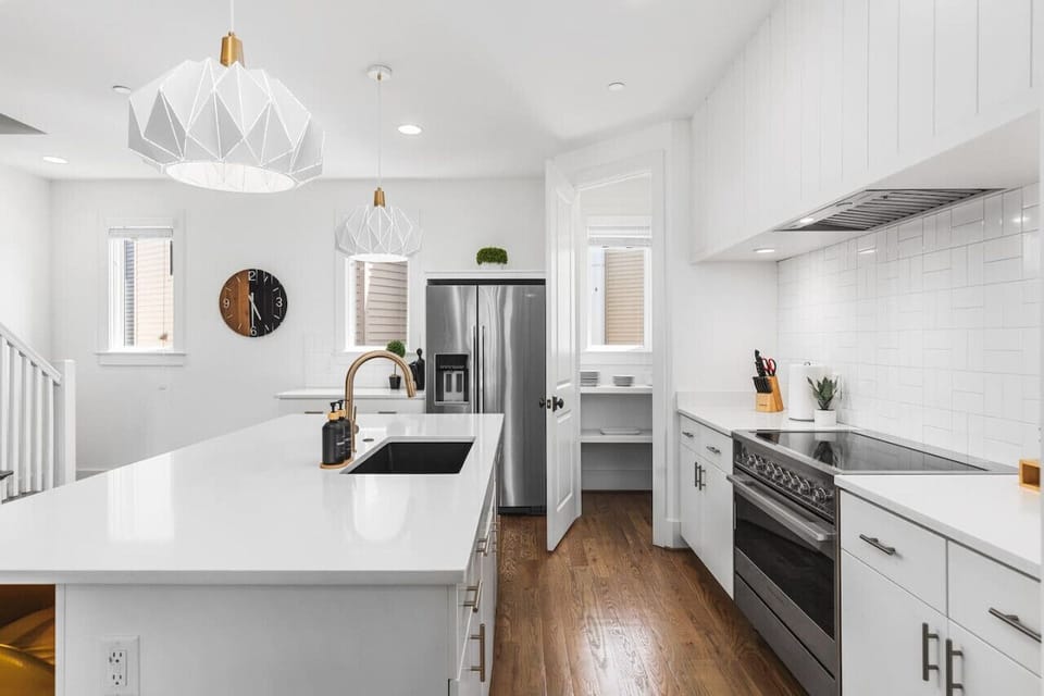 Bright and fresh kitchen with a large pantry & all the supplies you might need to share a great meal.