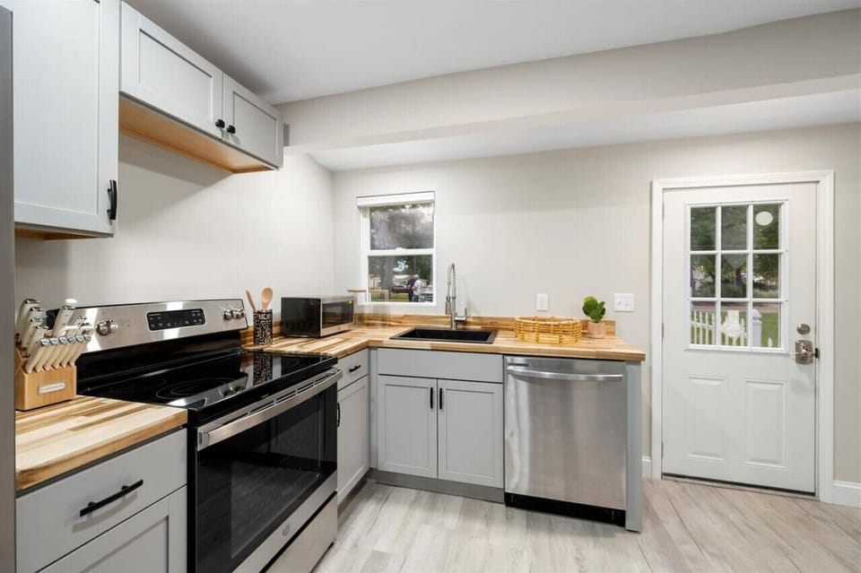Modern kitchen with ample counter space, complete with a range of appliances and utensils, ideal for preparing delicious meals.