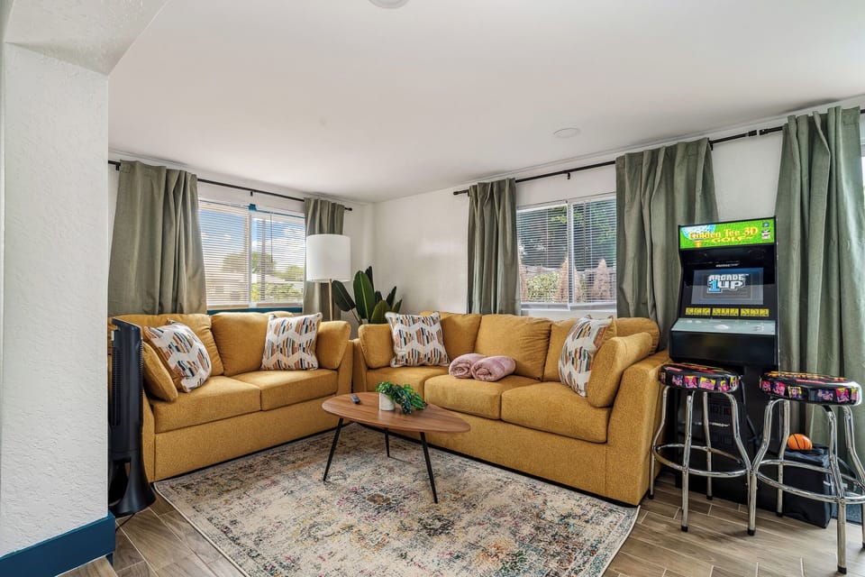 The living room features an arcade game, bringing entertainment and a playful touch. Queen Sofa bed that can sleep 2 if needed!