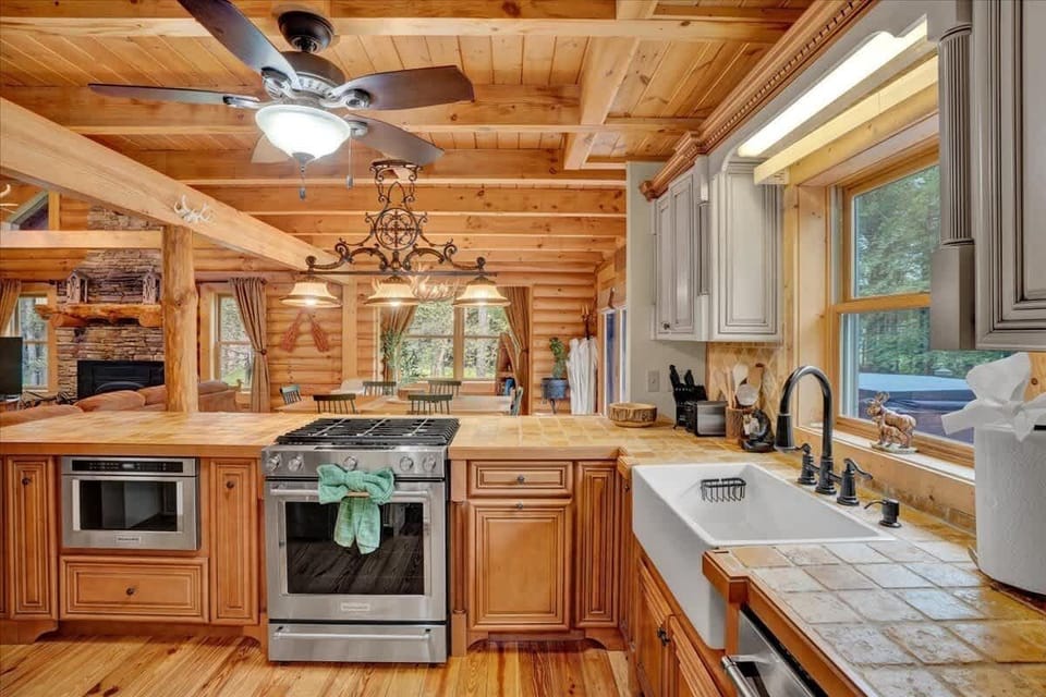 Modern Stainless Kitchen with Forest Views