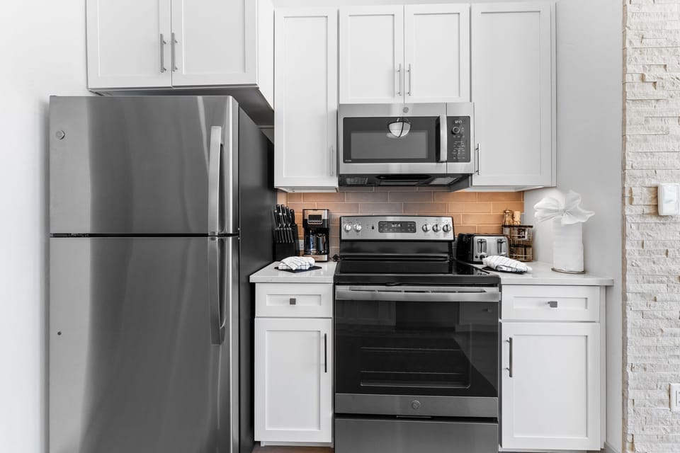 Full size kitchen with stainless steel appliances.