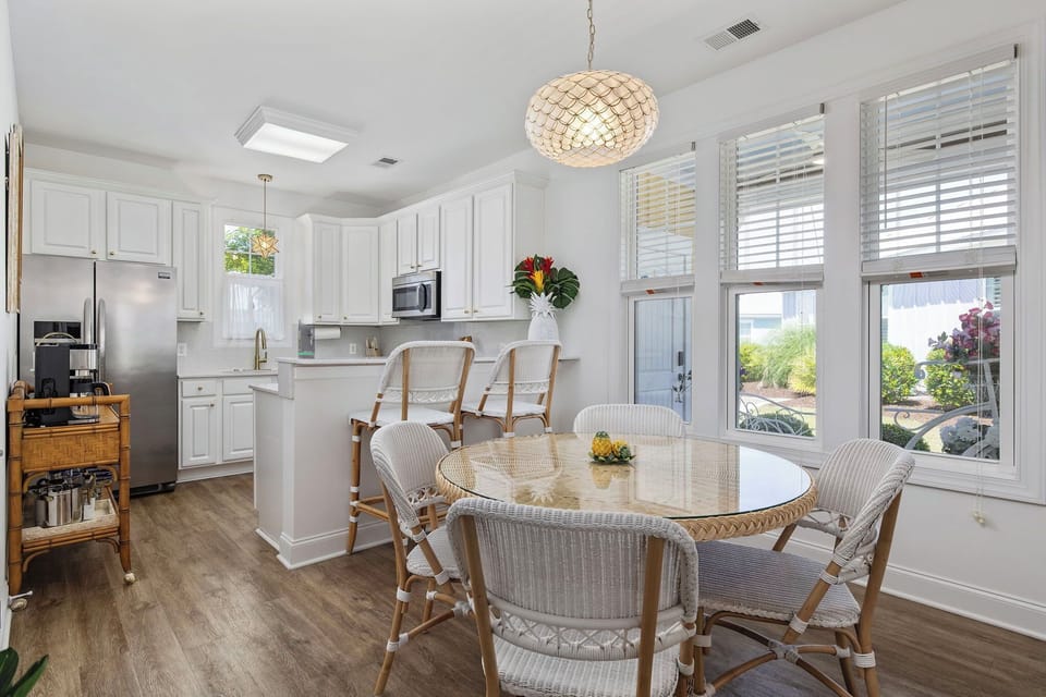 Spacious dining area with table and breakfast bar 