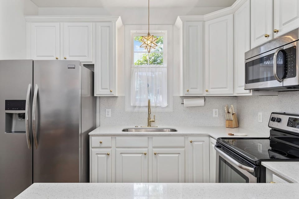Stainess steel appliances - refrigerator, stove, oven, microwave, & dishwasher.