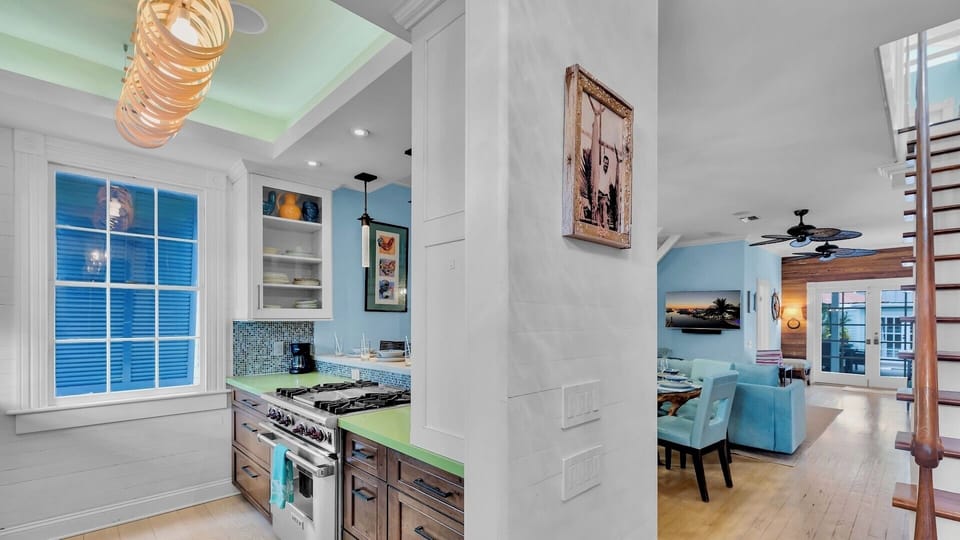 Step into your stylish open-concept retreat where the modern kitchen flows seamlessly into the cozy living space, perfect for memorable evenings.