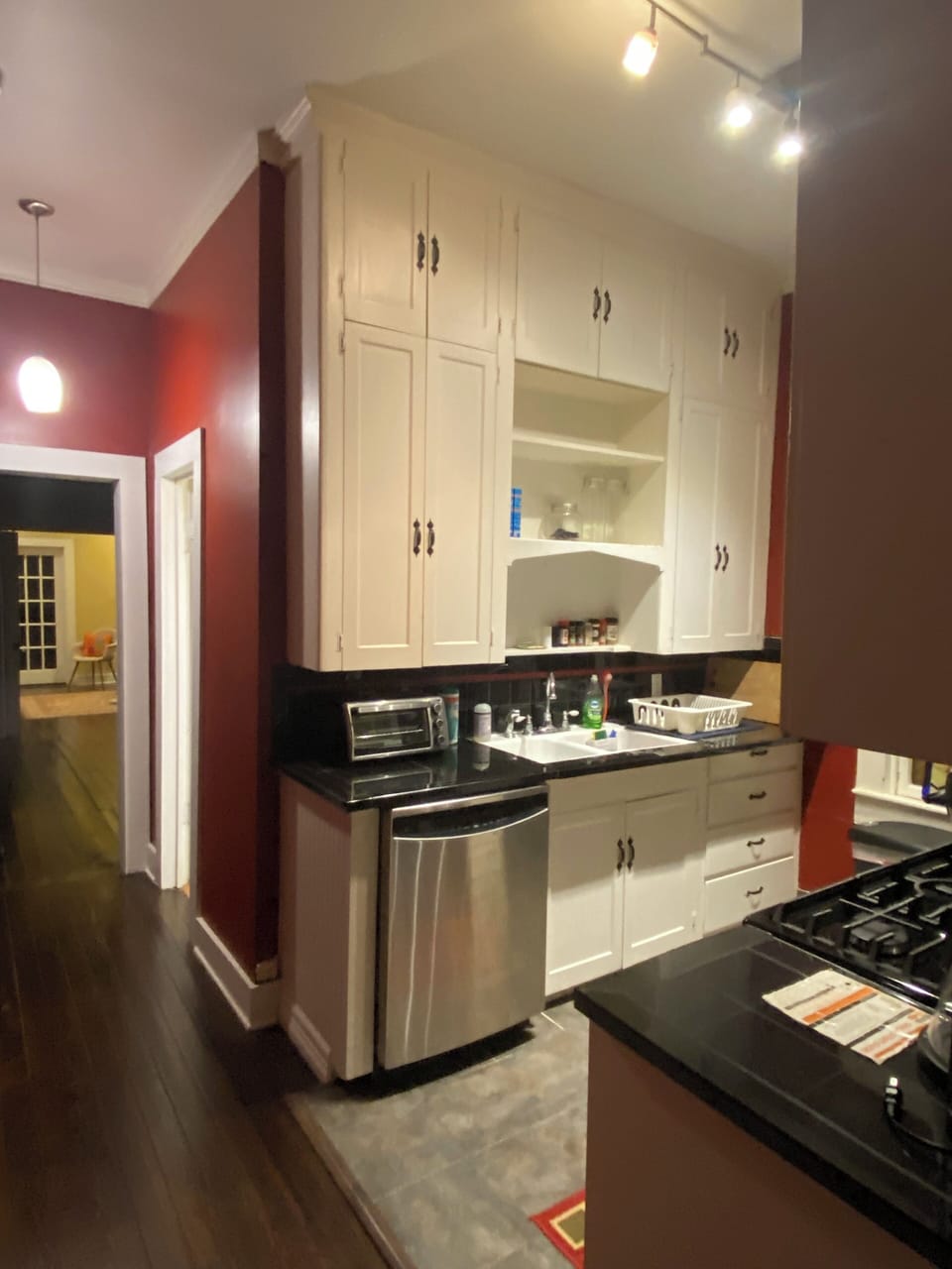 Kitchen equipped with a dishwasher, toaster oven, and drawers with flatware, etc