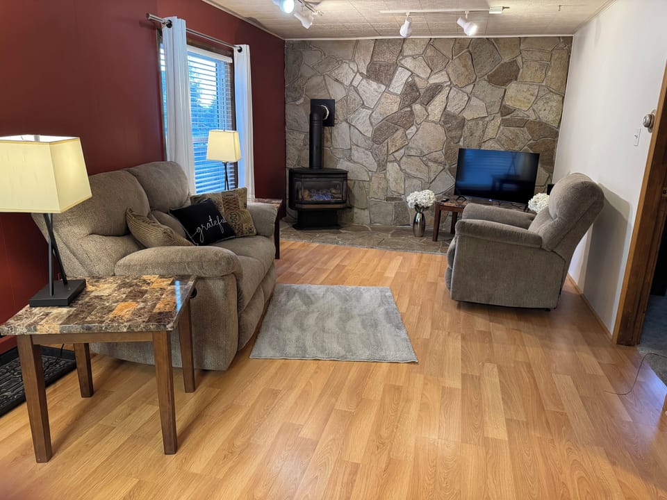 Living room with a gas fireplace and a smart TV.