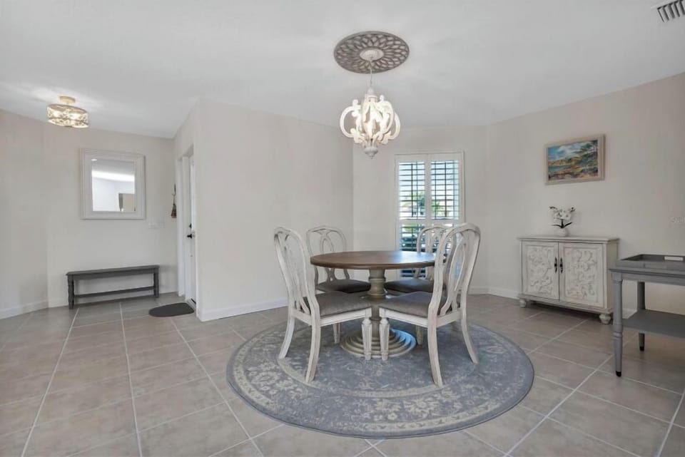DINING AREA IS LOCATED NEAR GAME ROOM WITH AMAZING VIEW TO CANAL/POOL