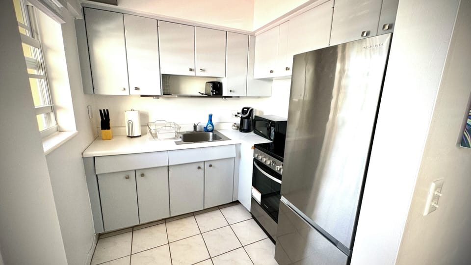 Full kitchen with stainless steel appliances. 