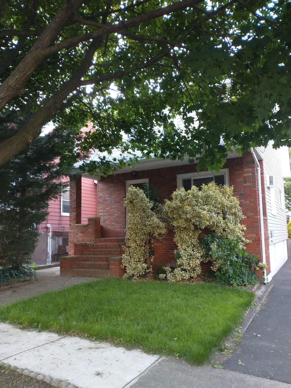 Front of the house with front porch and solar panels.