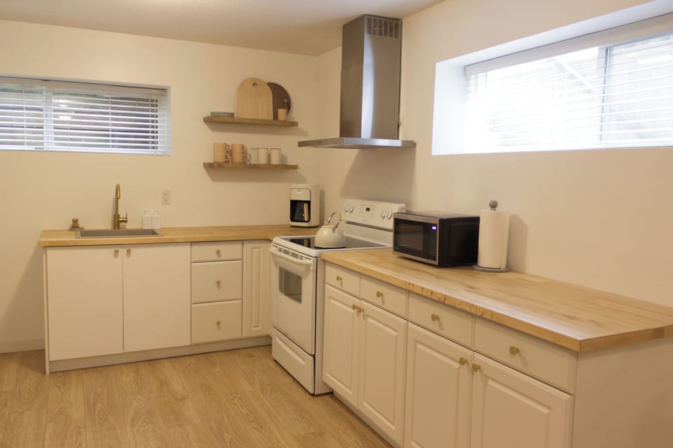 Kitchen with full size fridge and stove.