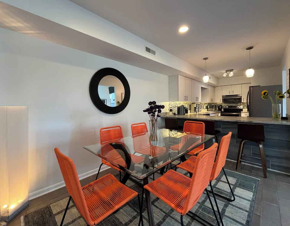 The dining table seats 6 plus 3 barstools at the kitchen counter/breakfast bar.