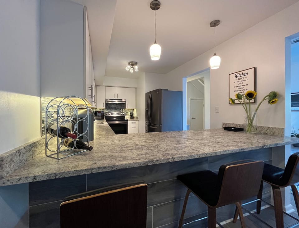 The breakfast bar/ kitchen counter with 3 seats provides a great place to keep the cook company or for additional dining chairs.
