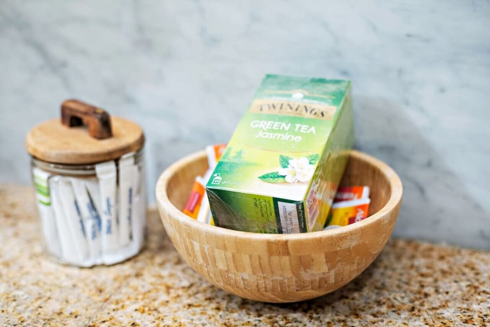 Tea Station: Sip on aromatic jasmine green tea in a stylish wooden bowl—your perfect retreat awaits!
