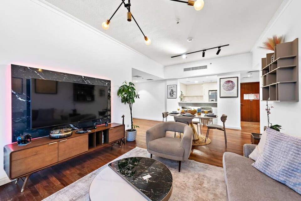 Living Room: Chic urban retreat with stylish decor, a smart TV, and inviting dining area!