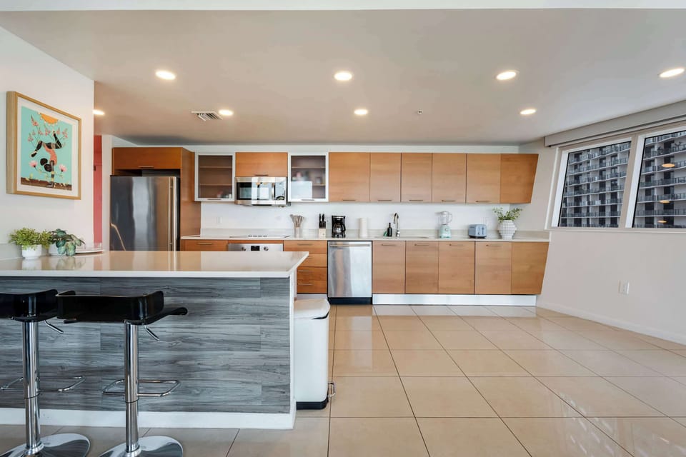 Sleek wooden cabinetry and stainless steel appliances make this kitchen as functional as it is beautiful.