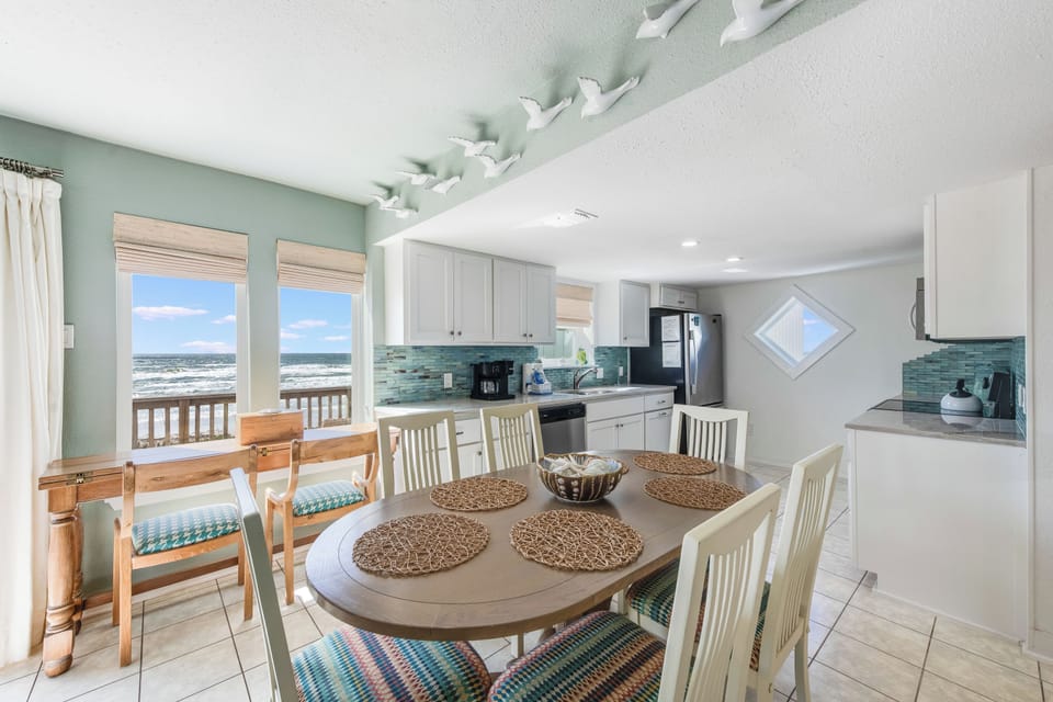 Your beachfront kitchen awaits with ocean views through every window, coastal colors, and space for memorable meals with loved ones.