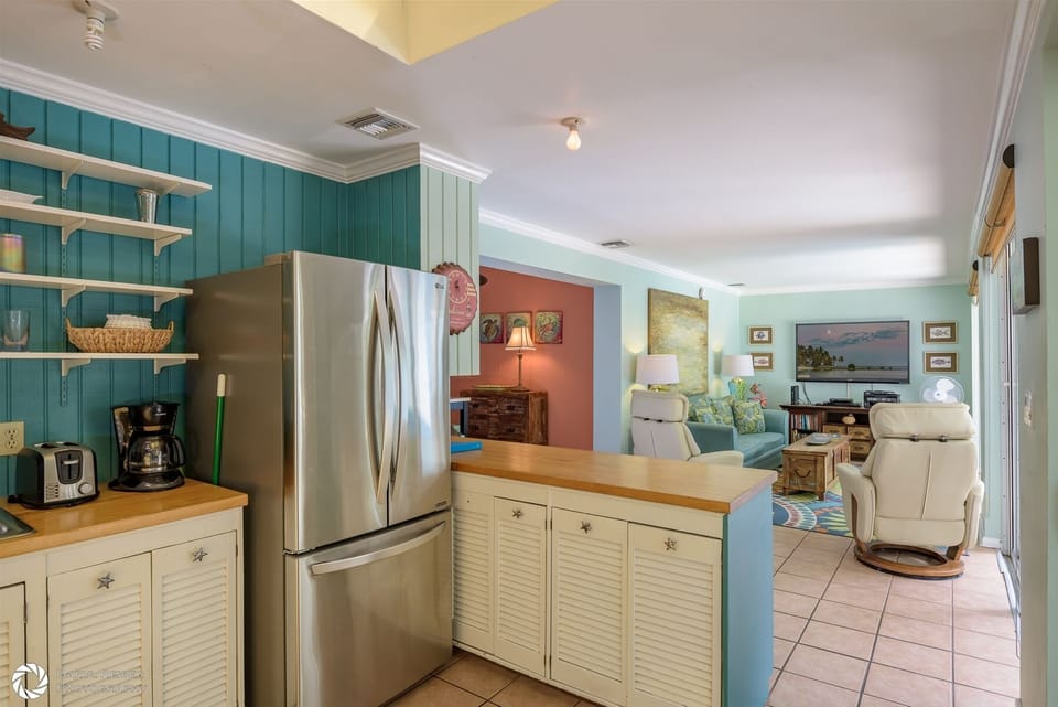 Full Kitchen and Breakfast Bar with view into Living Room