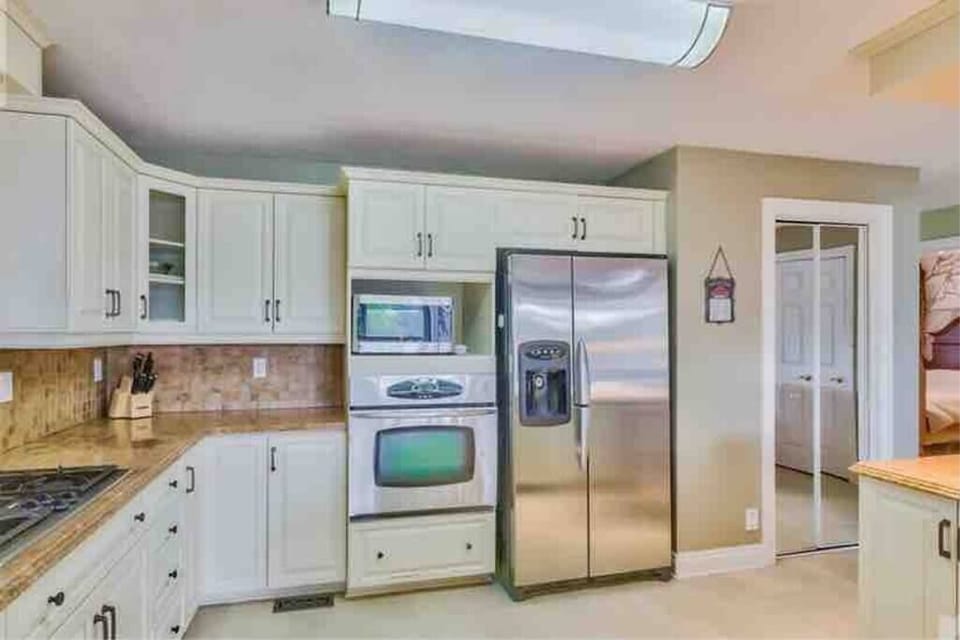 Fully stocked kitchen with cookware and dining essentials 