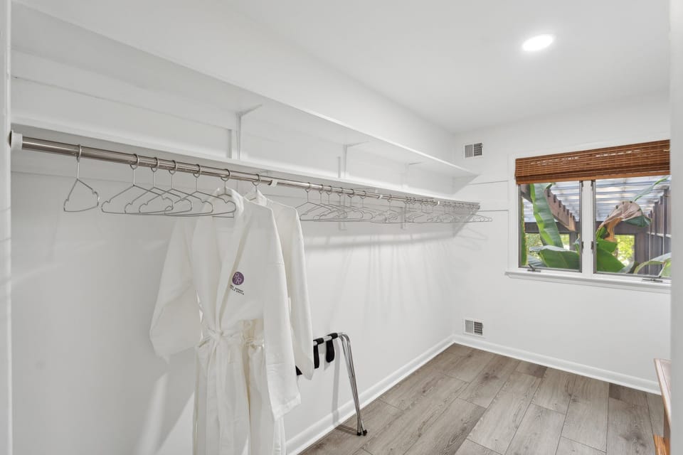 Large walk-in closet with custom robes in each bedroom