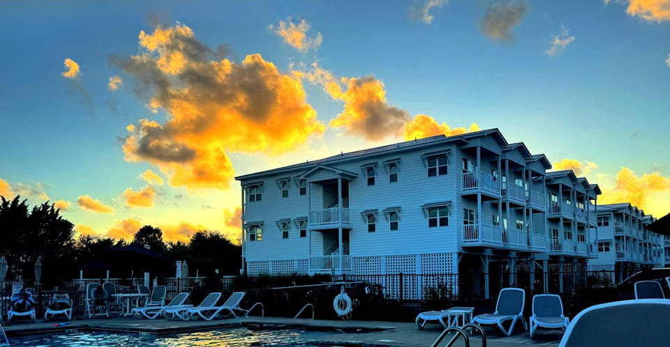 Waterfront resort pool at sunset