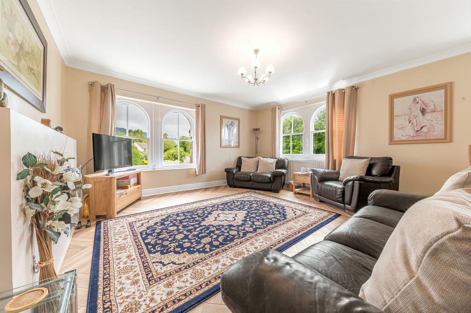The spacious living area is filled with light and enjoys lovely views over Lake Road its well maintained greenspaces