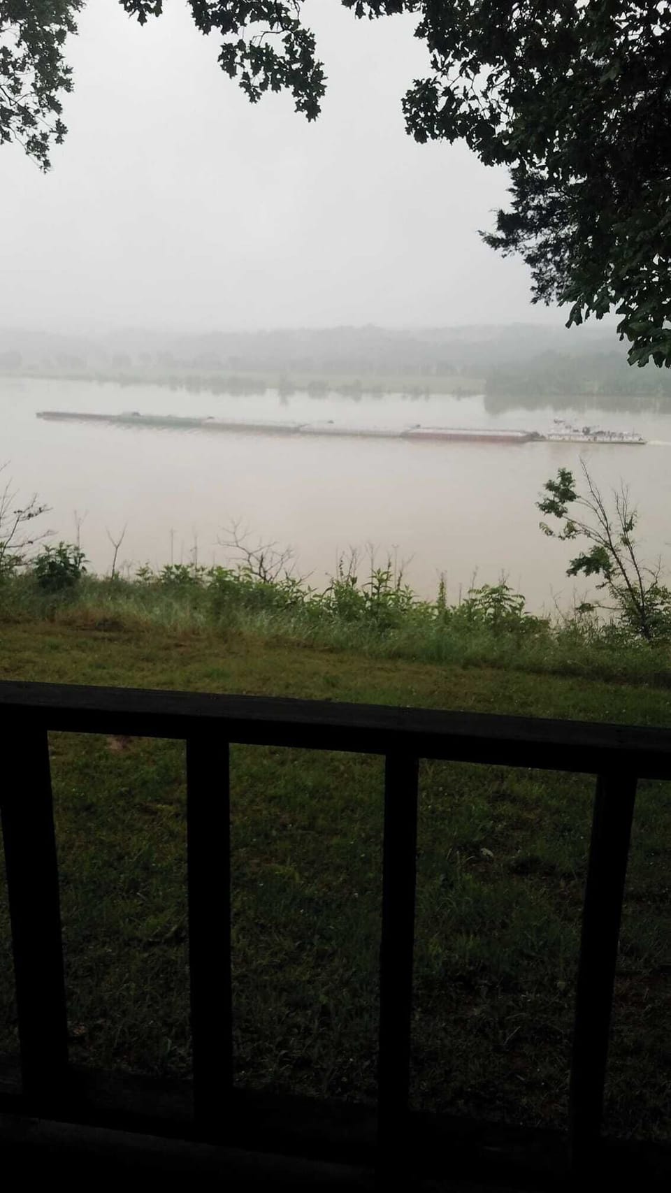 Barge moving down river in fog