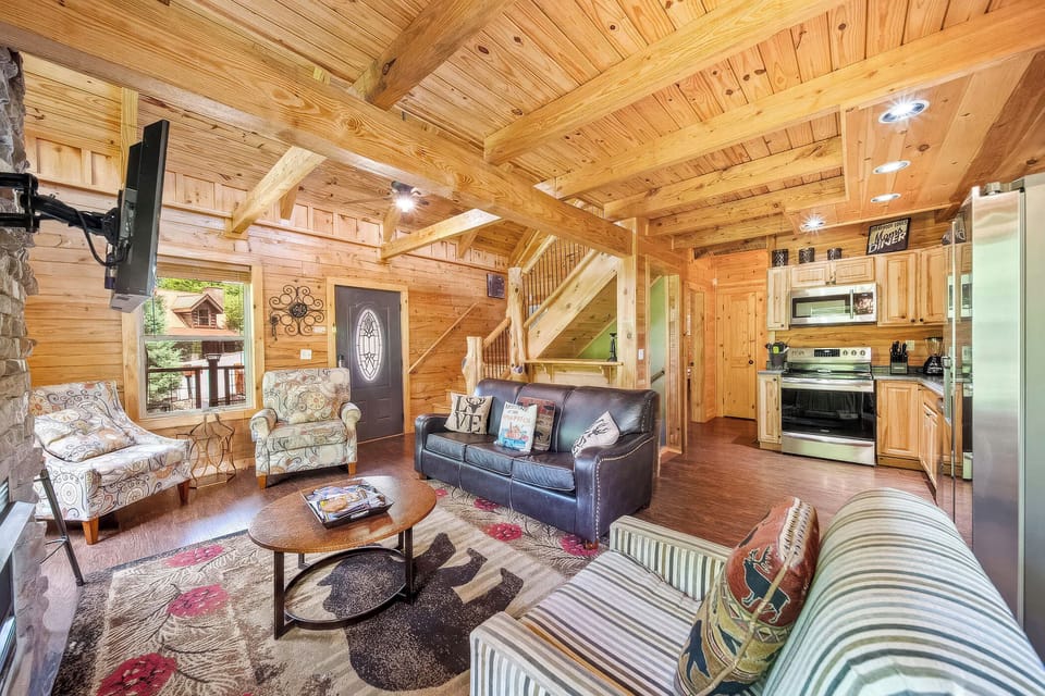 Enjoy mountain views from this inviting living space with a stone fireplace.