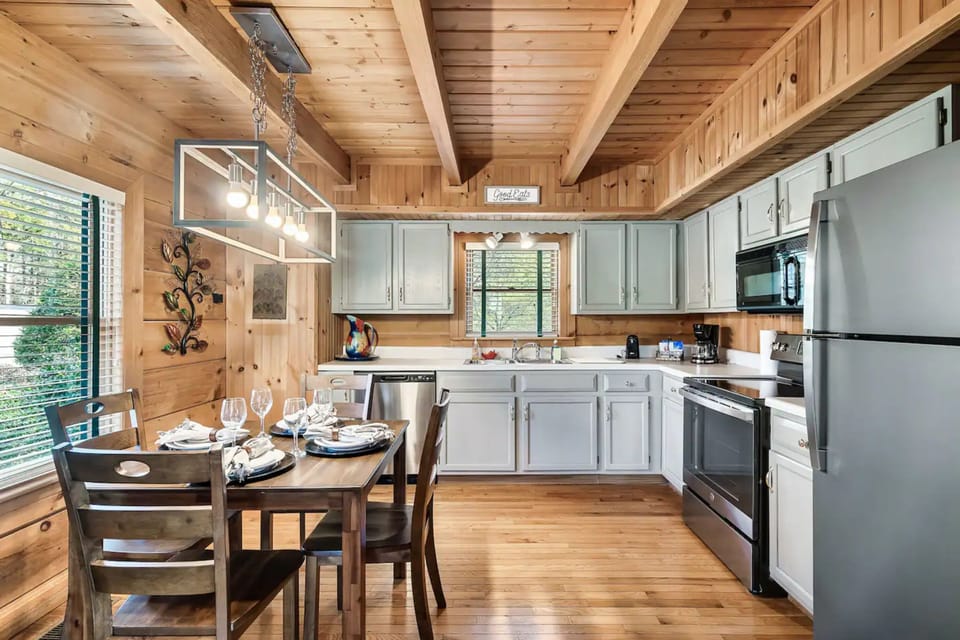 Step into this cozy cabin kitchen and dining area, the perfect spot to gather with friends and family 