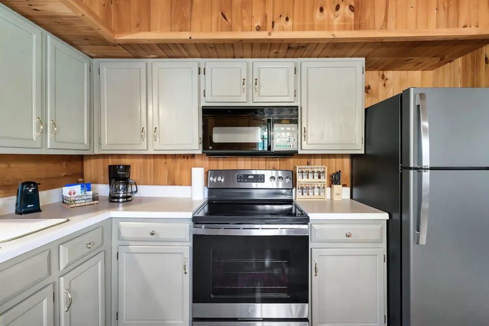 Step into the heart of the home where culinary magic happens with a fully-equipped kitchen featuring a stove, refrigerator, and microwave!