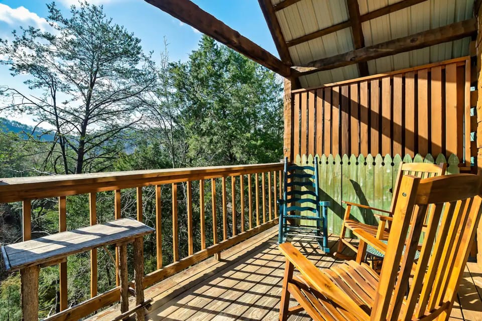 Sit back, relax, and enjoy the serene view from this charming wooden porch.