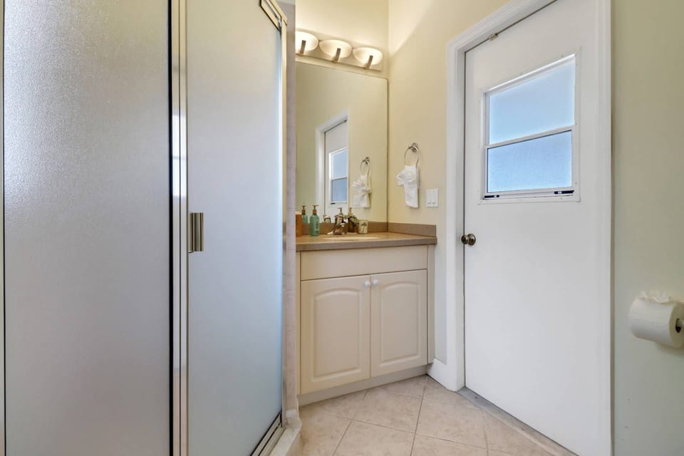 The pool bath (accessible from both the primary suite and lanai) has a stand up shower.