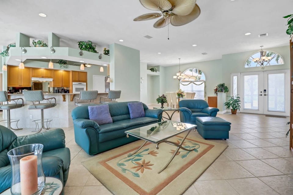 The main living area flows effortlessly into the open kitchen, with an eating bar with barstools dividing the two spaces.