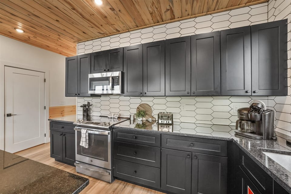 Sleek black cabinetry and modern appliances for culinary adventures!