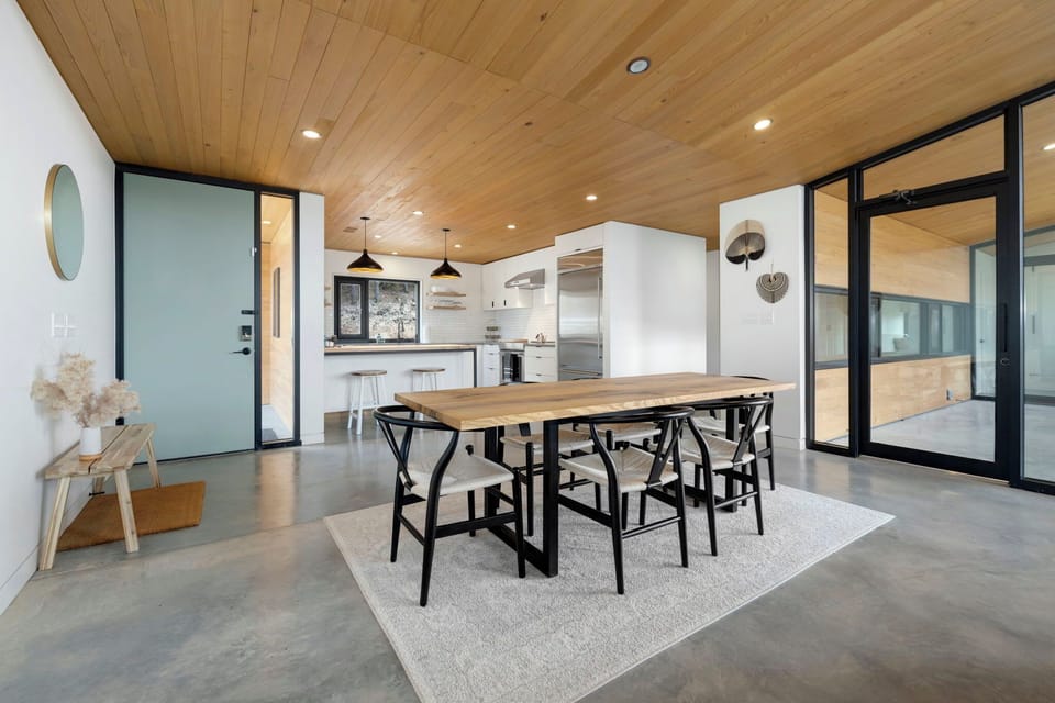 Inside, you will see our spacious, open concept kitchen and living space with an entire wall as a window providing nature views from all angles.