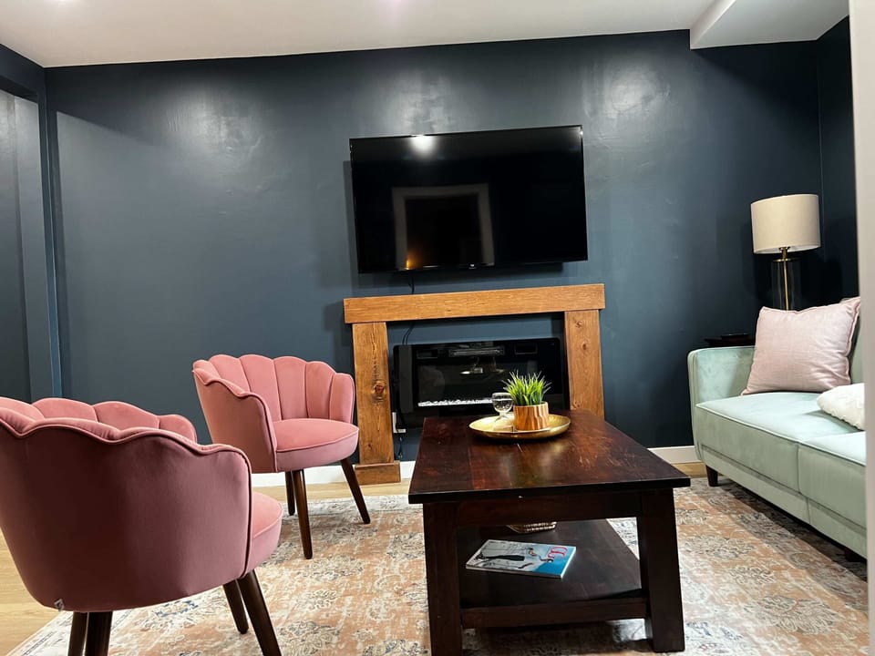 Chic meets comfort in this stylish living space with elegant gray décor and a cozy fire
