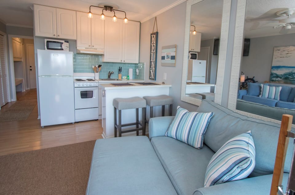 Living room, open to the kitchen.  Dining table with 2 chairs-removed bar stools