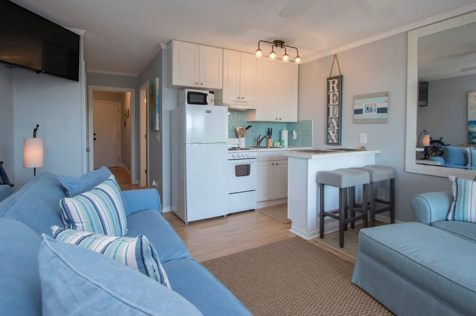 Living room is open to the kitchen.  There is a dining table with 2 chairs now.