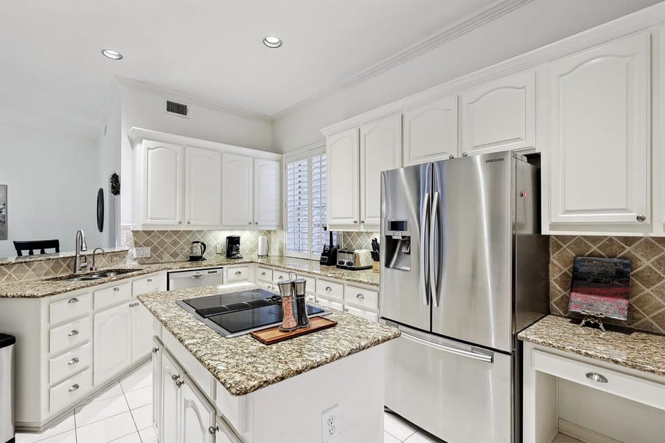 Bright, spacious, and functional with quartz countertops, a kitchen island, and plenty of counter space, this is the kitchen of your dreams – and it’s all yours to enjoy!