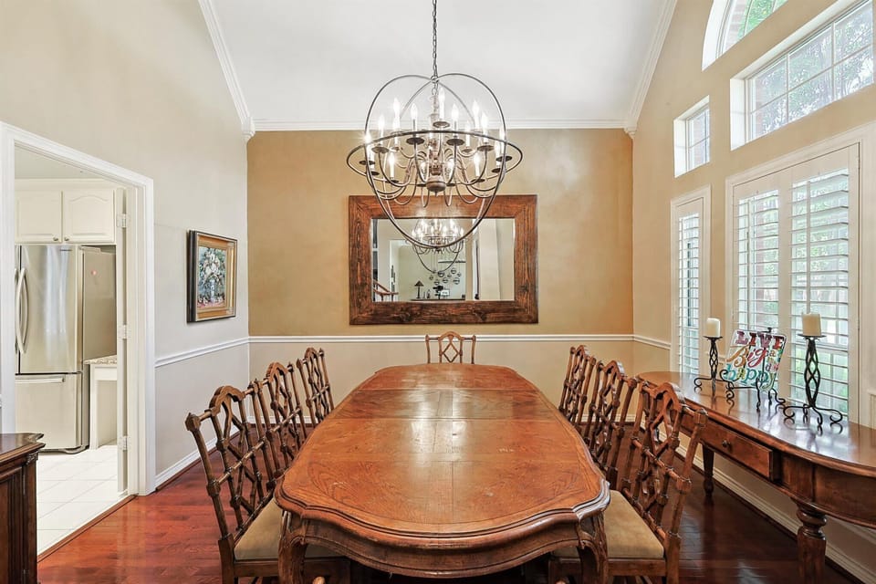 Featuring arched ceilings, plenty of natural light, and rich wood tones, this formal dining room offers an elegant and classic space for you to enjoy your meals in.