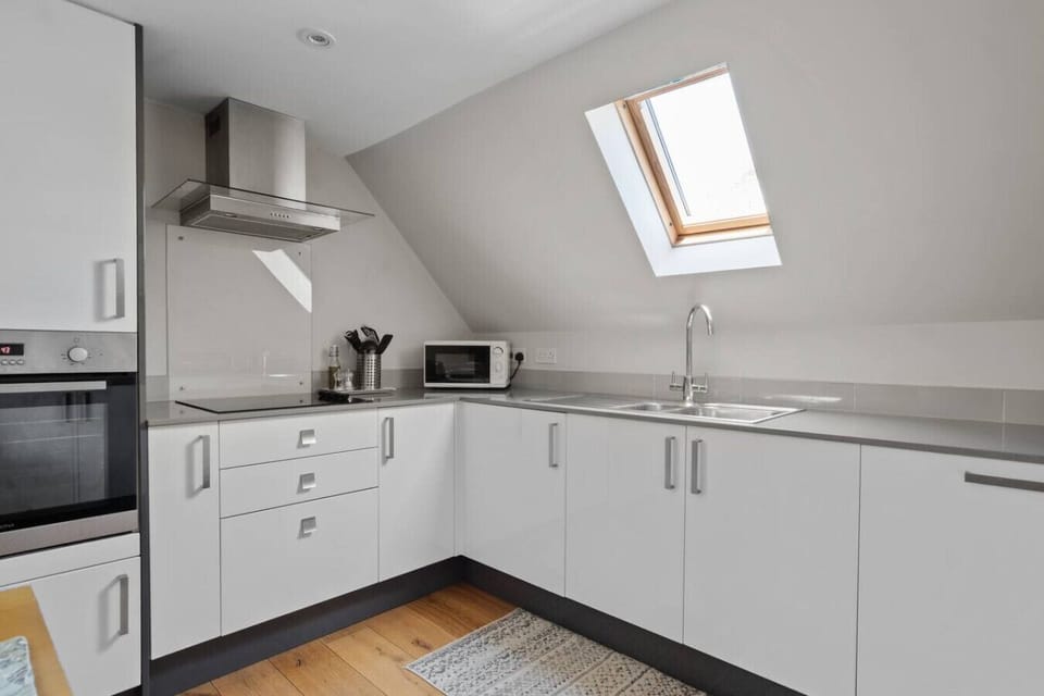 Fully fitted kitchen with skylight and modern appliances
