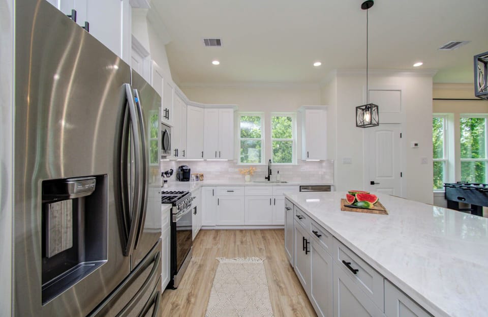 Spacious kitchen counter island and a large refrigerator