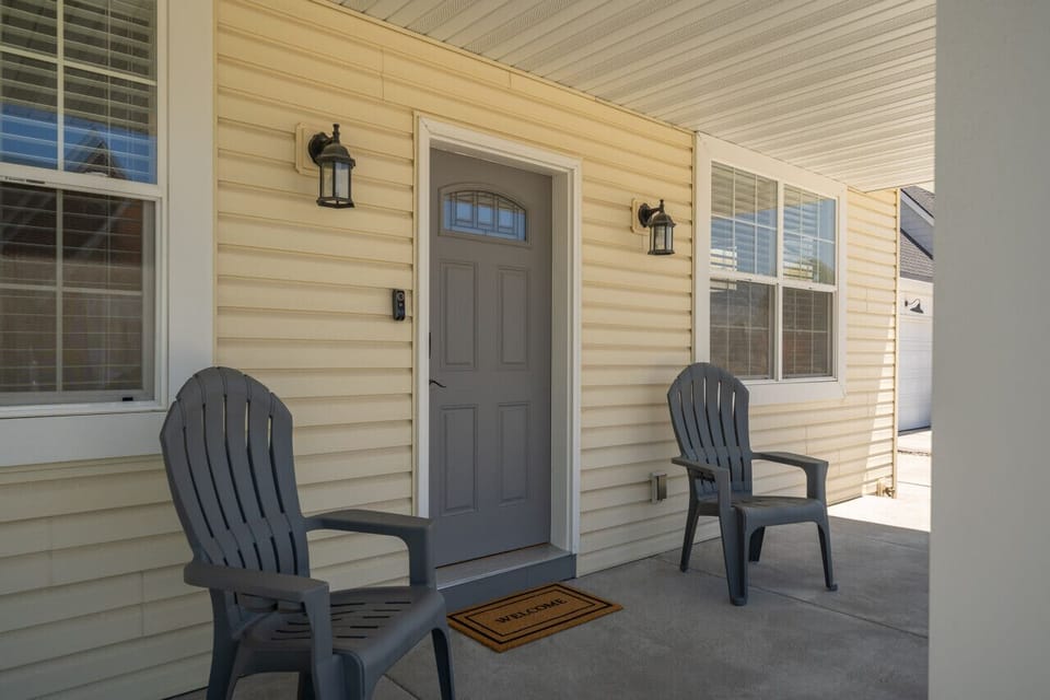 Inviting front porch with comfortable seating, perfect for relaxing and enjoying the neighborhood.