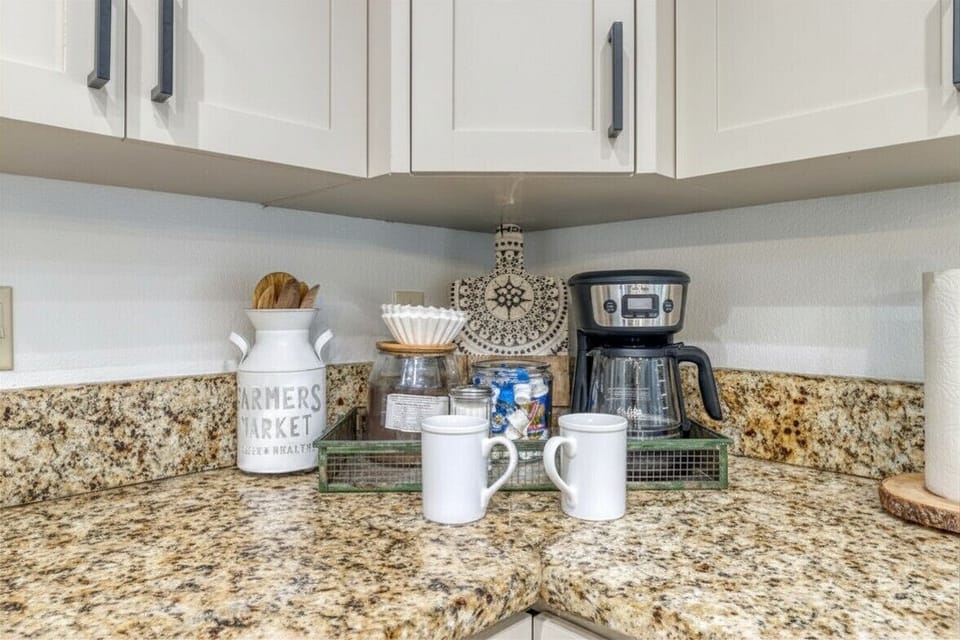 Convenient coffee station with mugs and essentials.